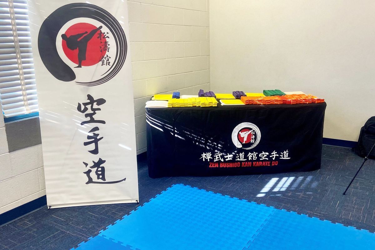 A room with a table and a sign that says karate