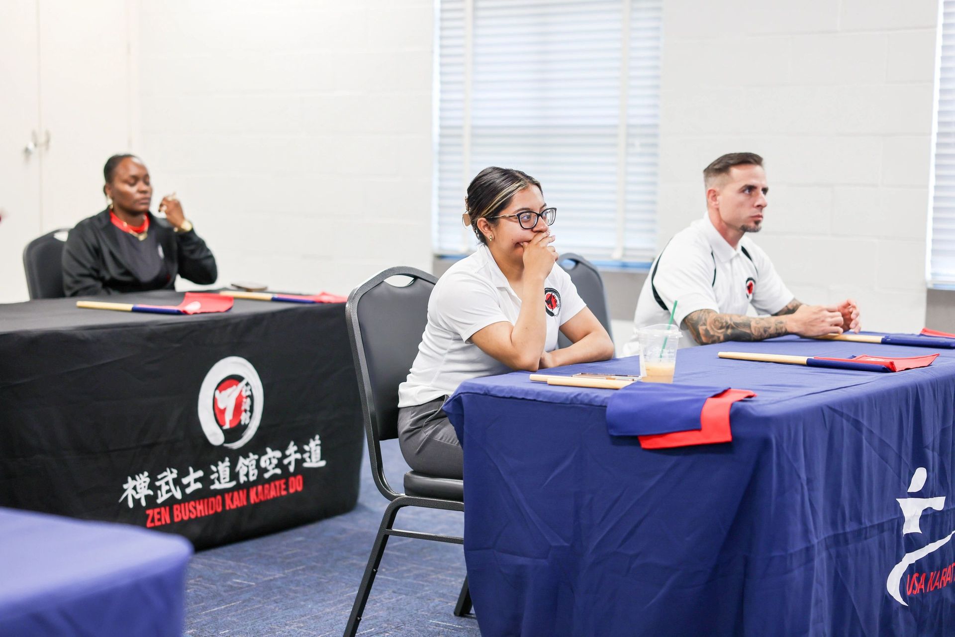 A group of people are sitting at tables in a room.