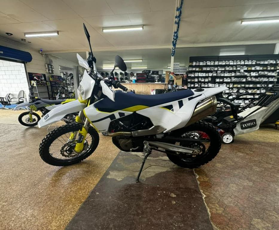 A White And Blue Dirt Bike Is Parked In A Garage — Extreme Motorcycles In Atherton, QLD