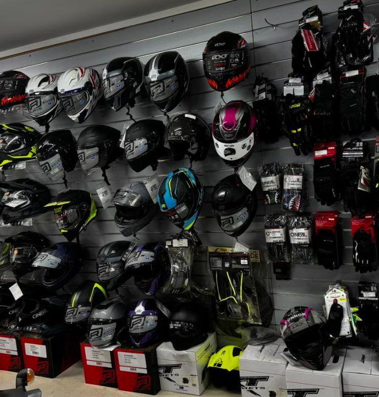 A Wall Full Of Motorcycle Helmets And Gloves — Extreme Motorcycles In Atherton, QLD