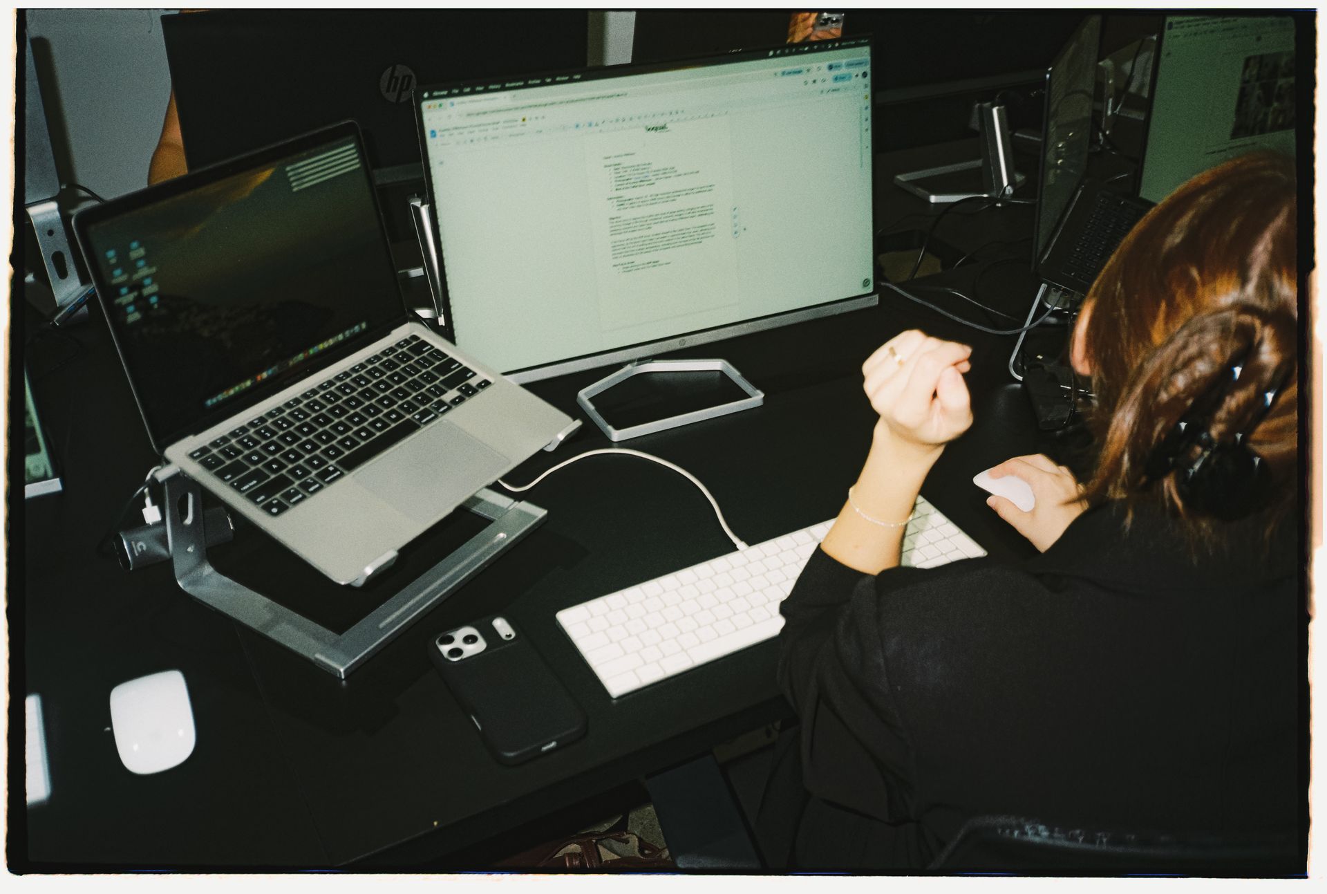 A woman working at a computer with SEO data displayed on the screen.