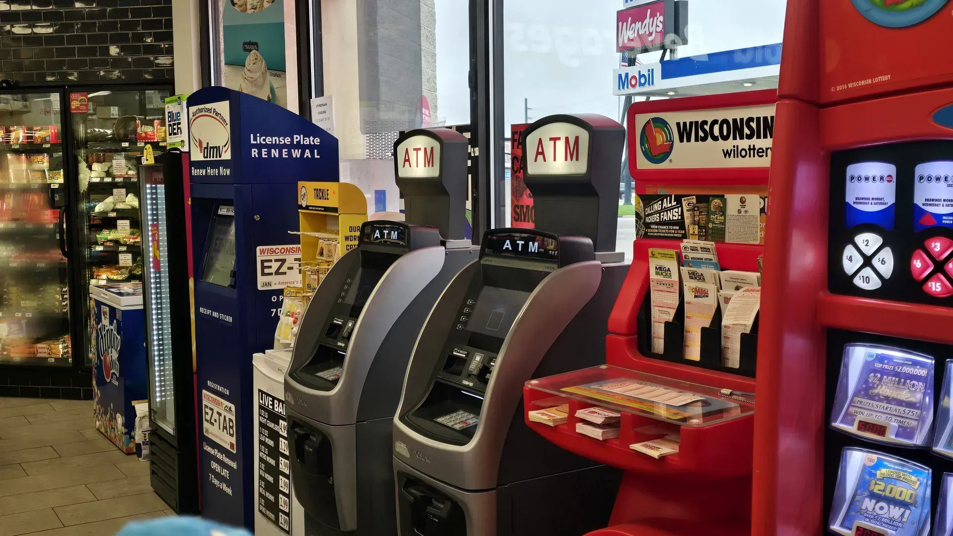 TA Janesville convenience store with ATMs, lottery machine, license renewal, and live fishing bait machines.