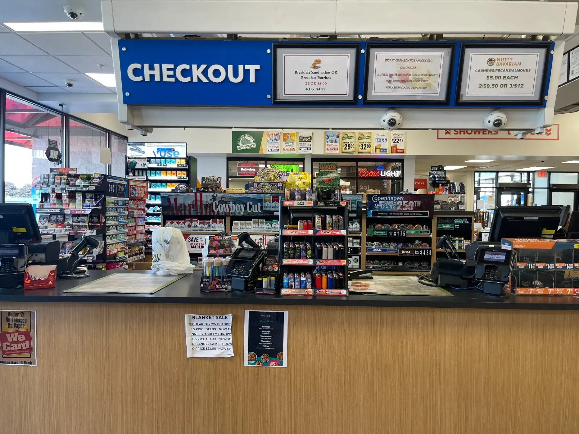 Checkout area inside TA Janesville Travel Center convenience store with tobacco products and travel items behind the counter