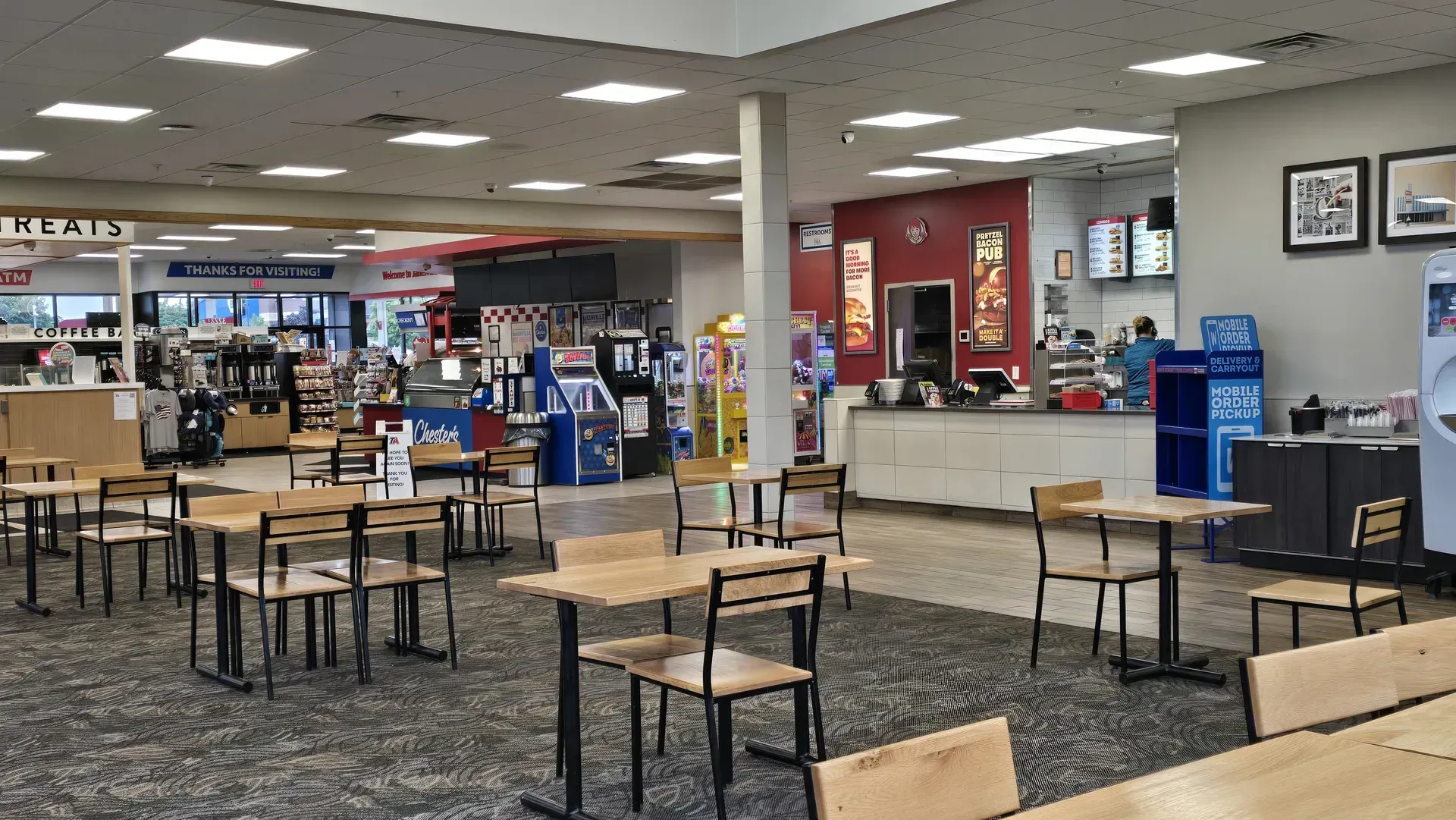 Empty cafeteria with tables and chairs, vending machines inside the gas station off I-90 in Janesville, WI