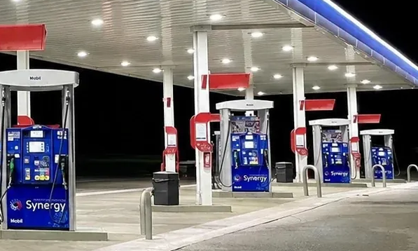 TA Janesville Travel Center's gas station pumps at night with blue Synergy pumps under a bright canopy