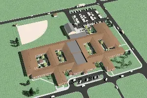 Aerial view of a large tan-roofed building with parking lots and green lawns.