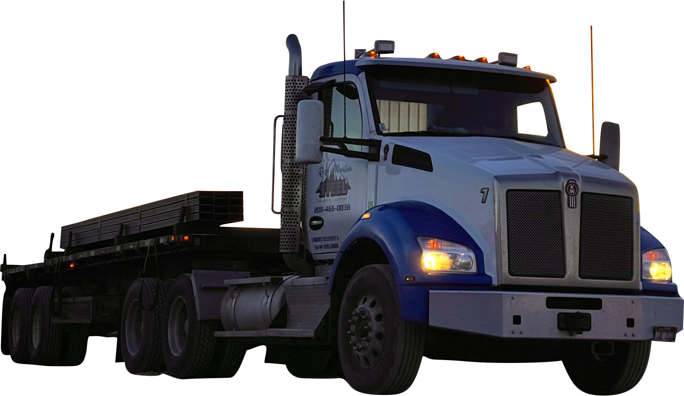 A black semi truck with a trailer full of pallets on a white background.