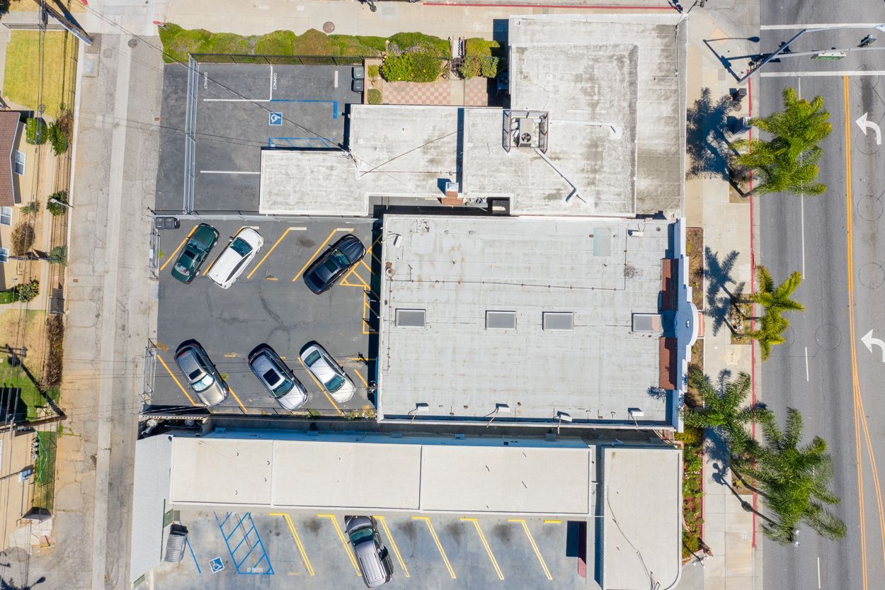 An aerial view of a parking lot with cars parked in it
