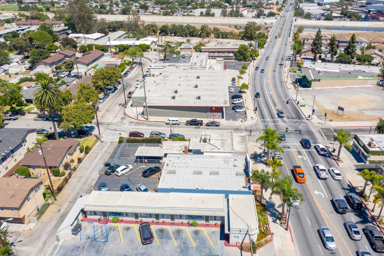 An aerial view of a busy city street with cars driving down it.