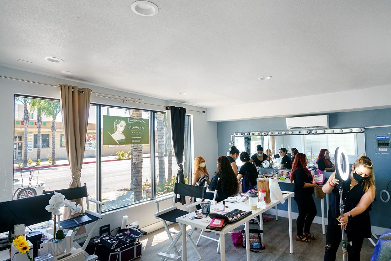 A group of people are standing around tables in a room.