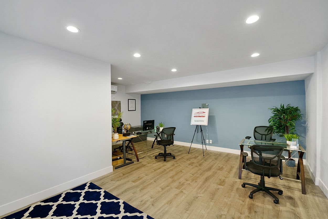 There are two desks and chairs in the room.