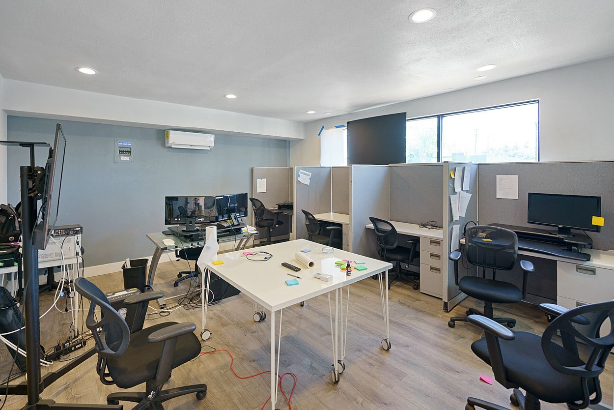 A room with a lot of desks and chairs in it.