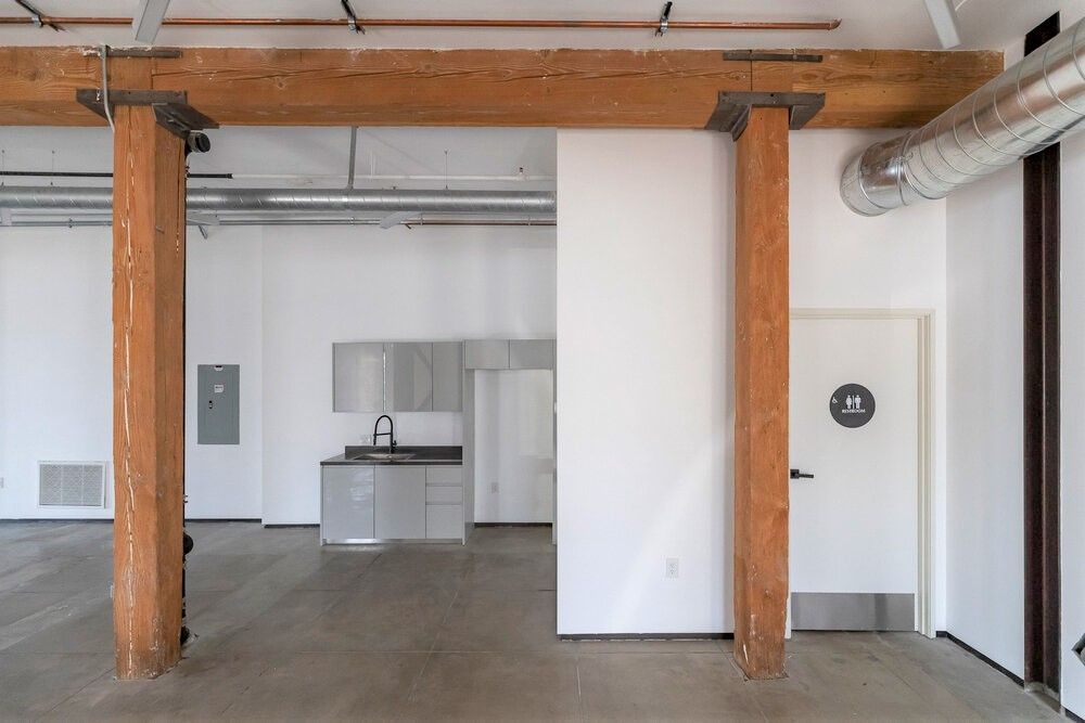 An empty room with a wooden pillar and a door