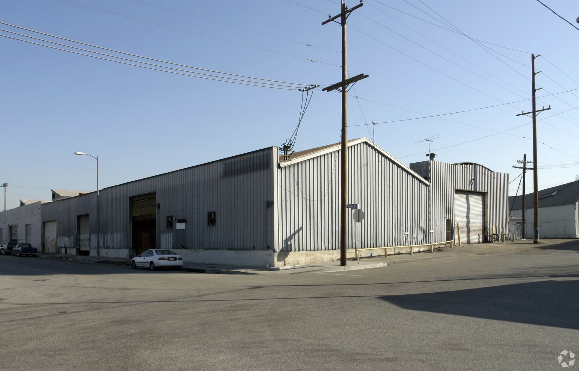 A warehouse with a car parked in front of it