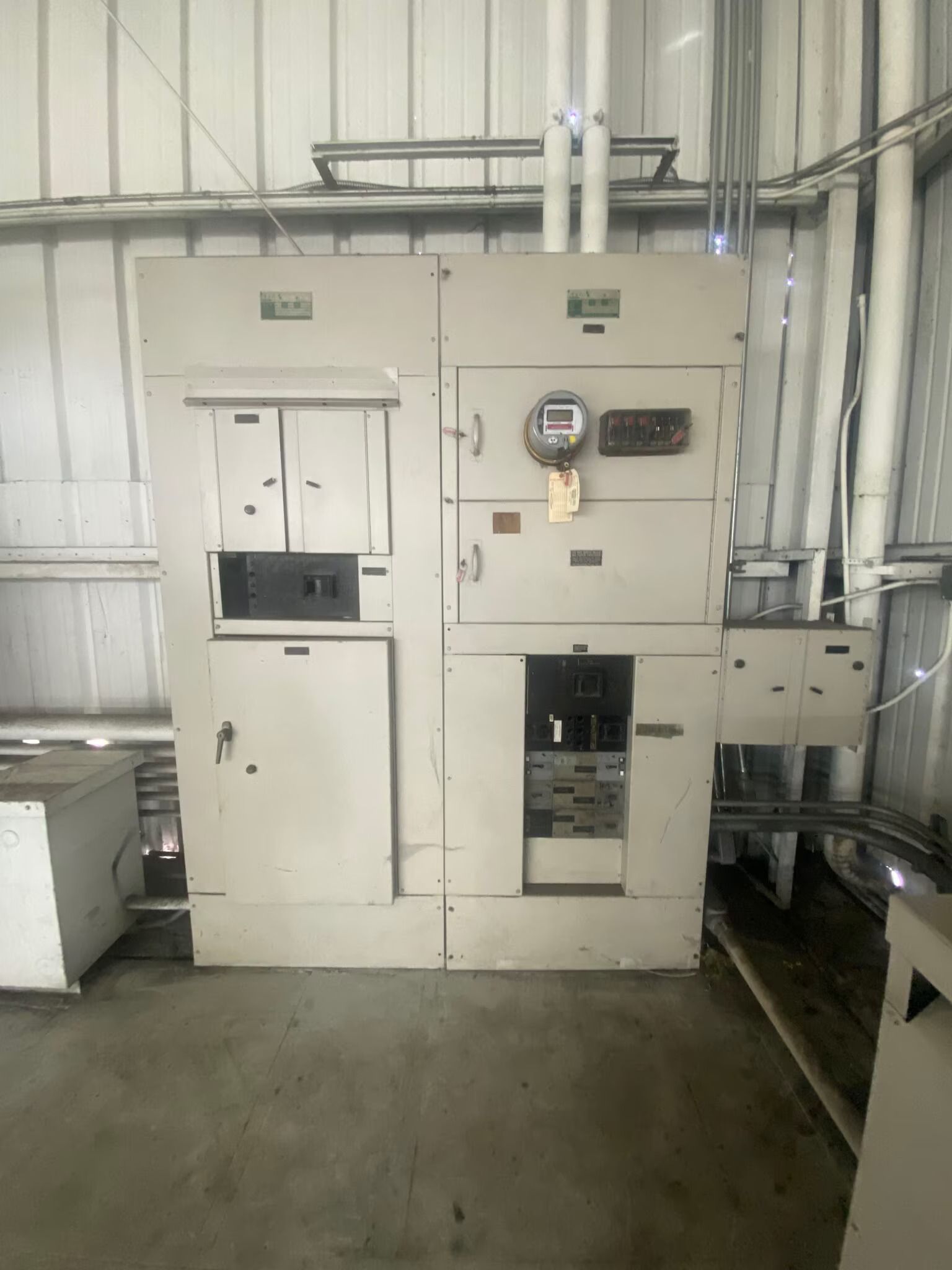 A large electrical panel is sitting in a warehouse.