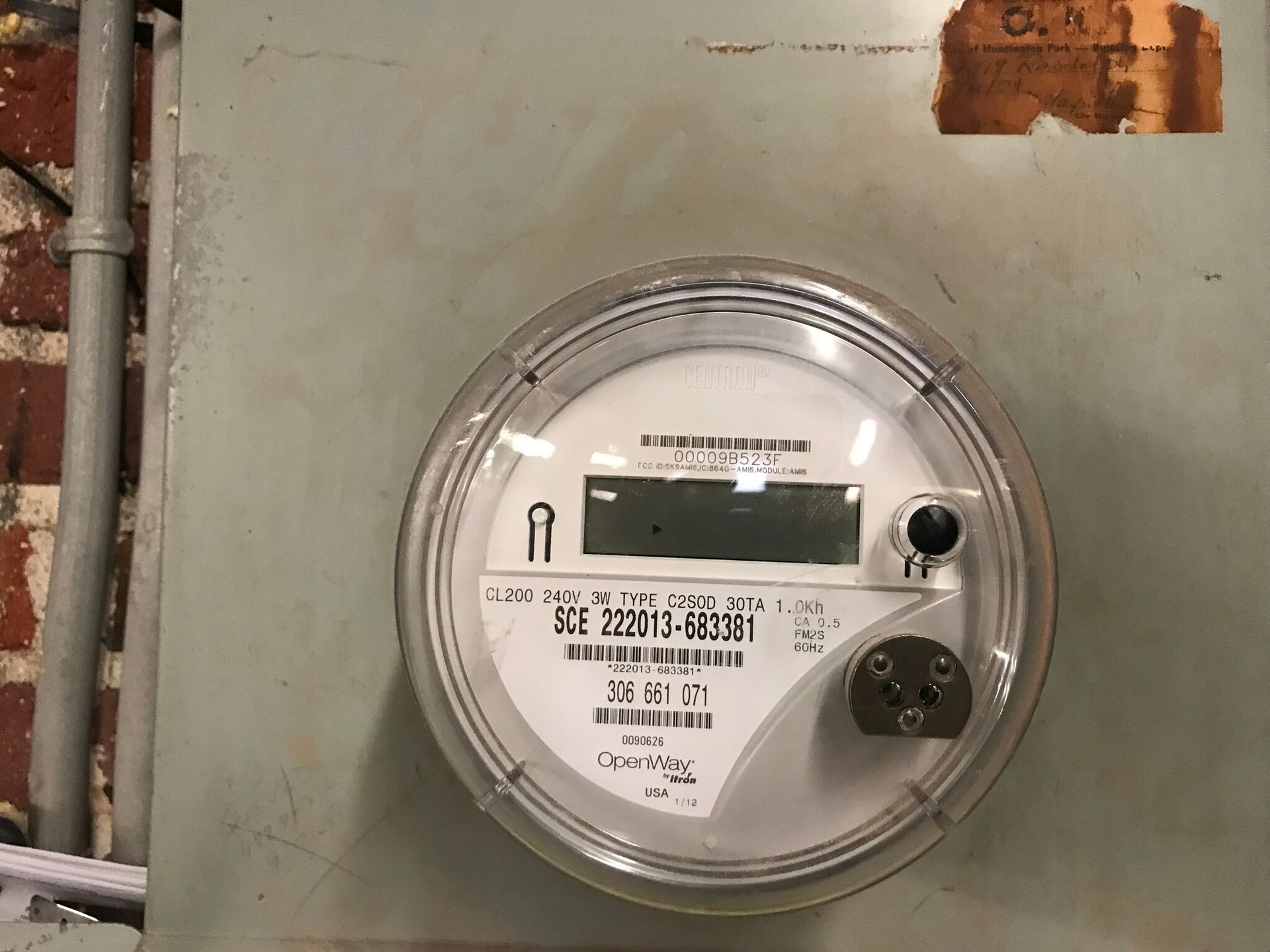 A close up of an electric meter on a wall
