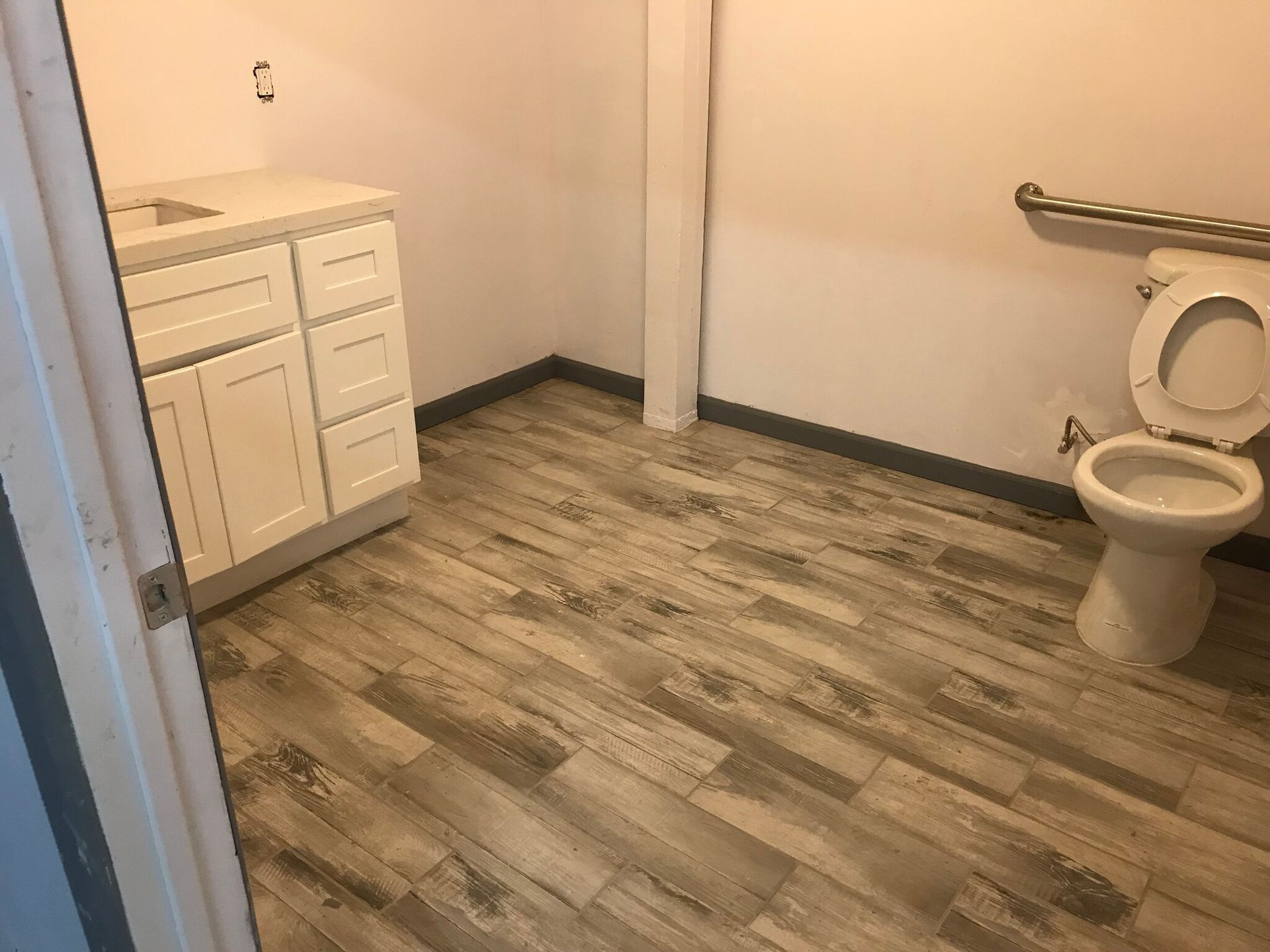A bathroom with a toilet and a sink in it.