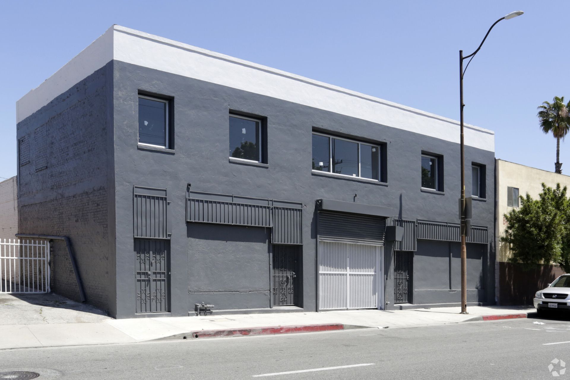 A building with a lot of windows and a car parked in front of it