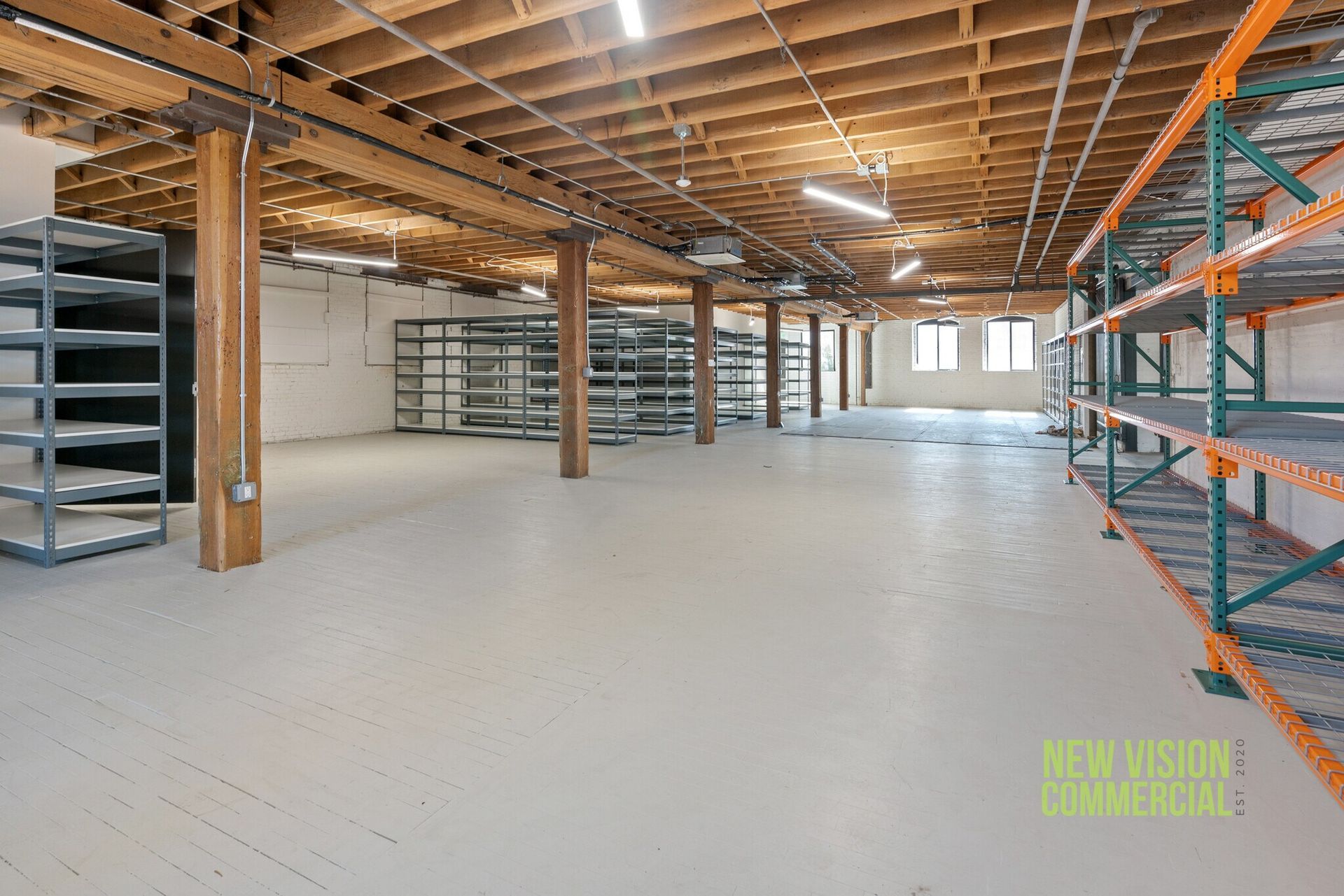 A large warehouse with lots of shelves and wooden beams.
