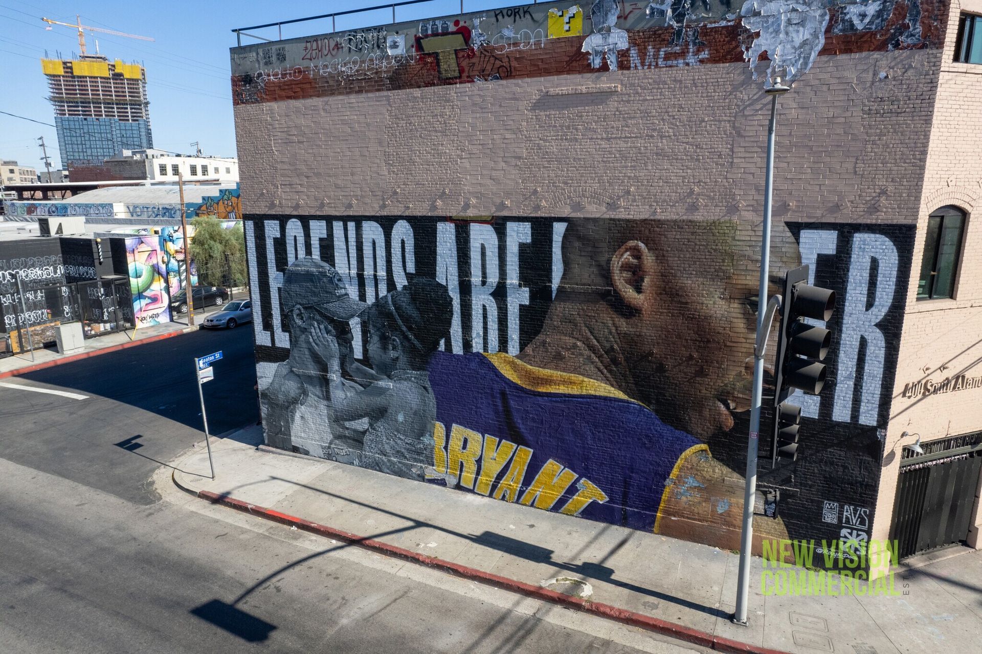 A large mural of basketball player kobe bryant on the side of a building.