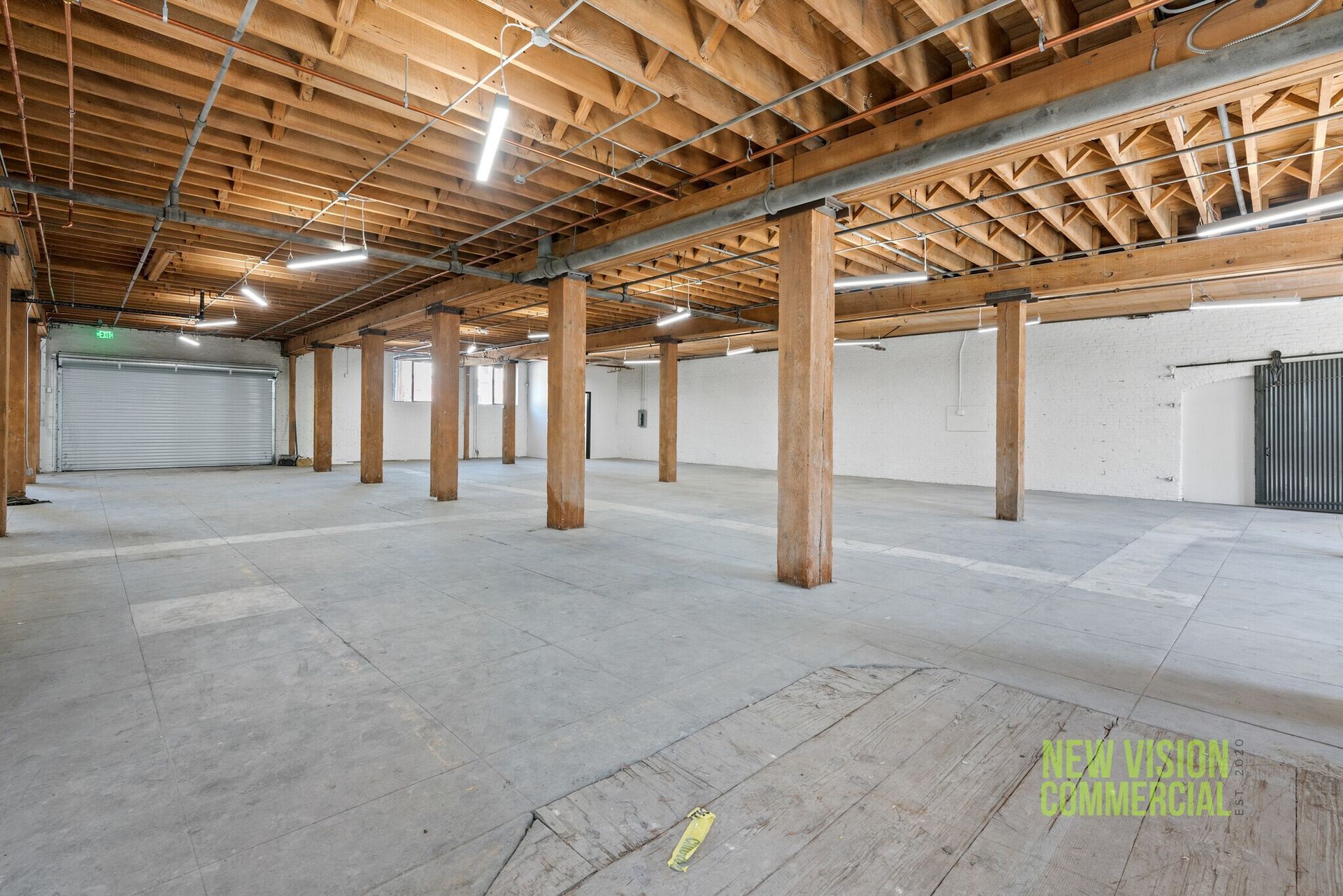 A large empty building with wooden beams and columns