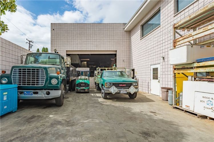 A group of trucks are parked in front of a building.