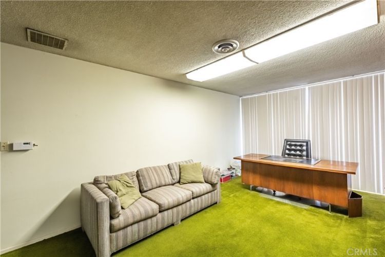 A living room with a couch and a desk