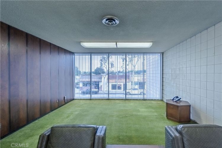 A room with a lot of windows and chairs in it