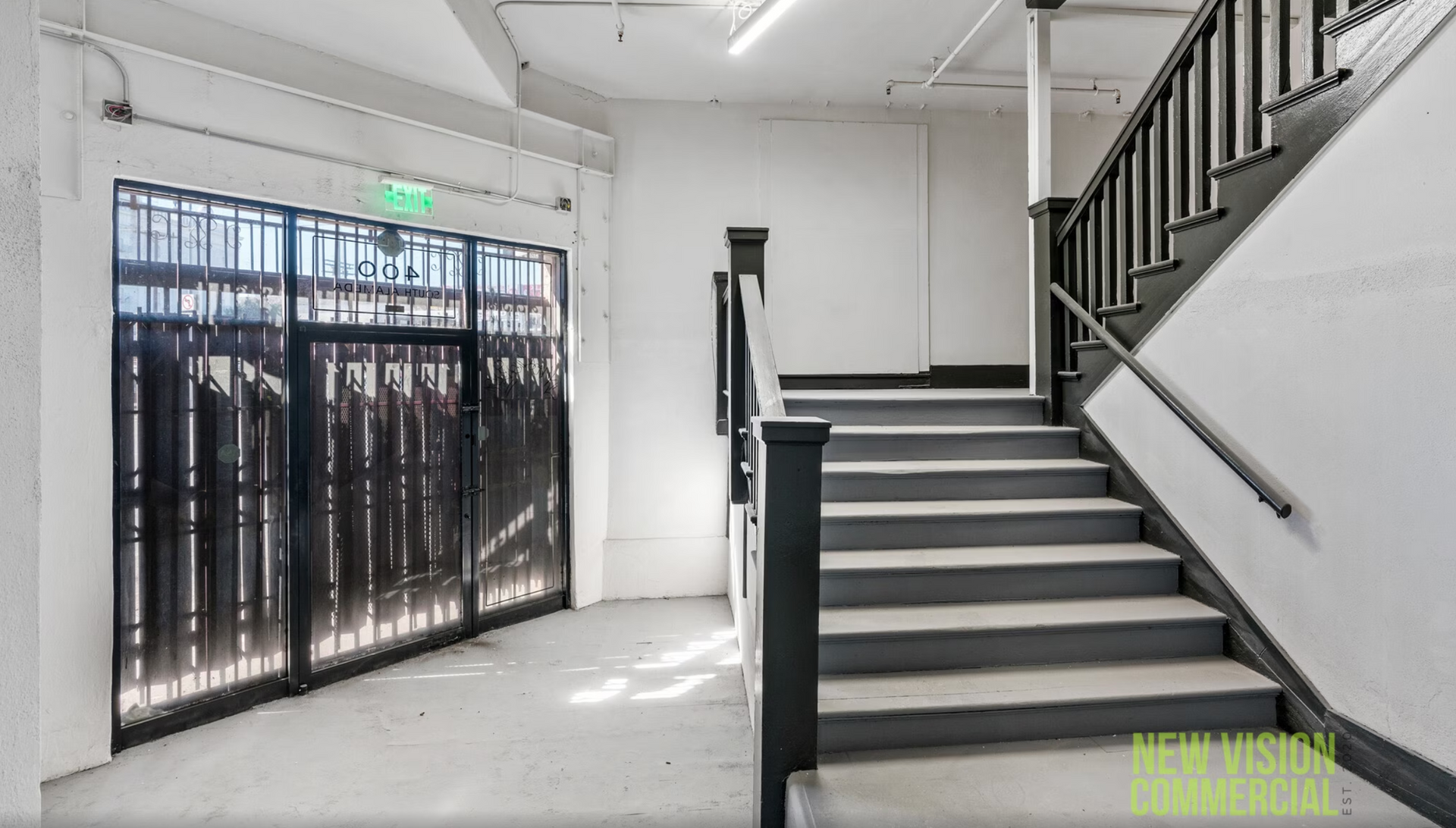 A staircase in a building with a gate and a railing.