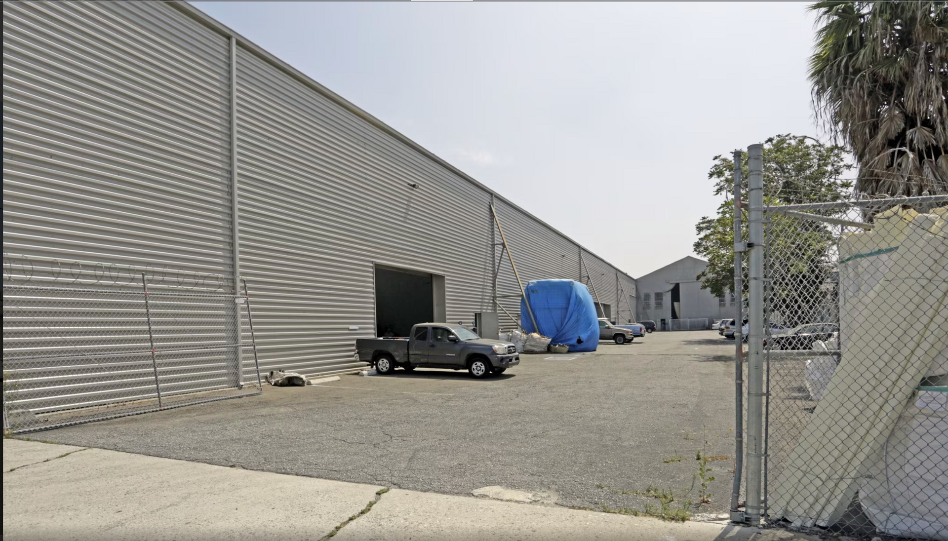 A truck is parked in front of a large building
