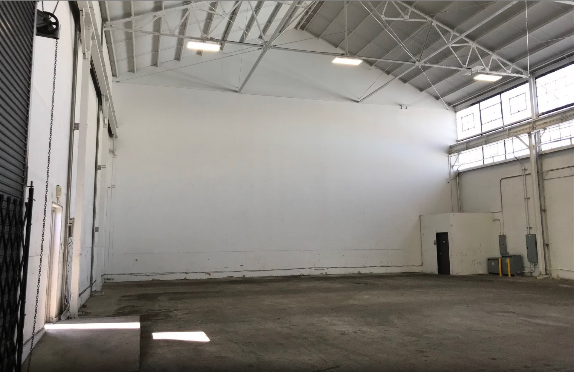 A large empty warehouse with a lot of windows