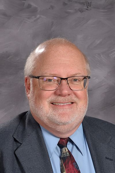 Head shot of Rev. Tom Mielke smiling at the camera