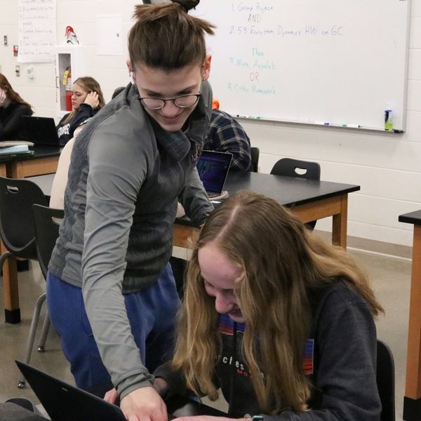 Mrs. Dorn working with a student who is playing 