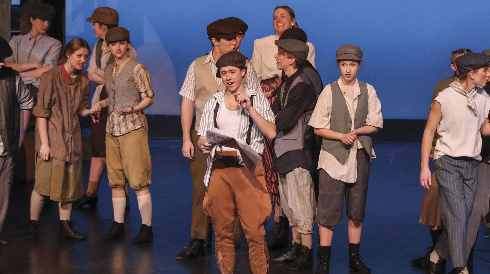 Ian Luehring, performing during Newsies