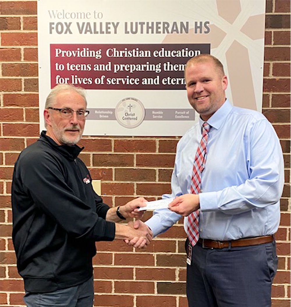 Mr Loberger receiving a check from Bargain Garden treasurer