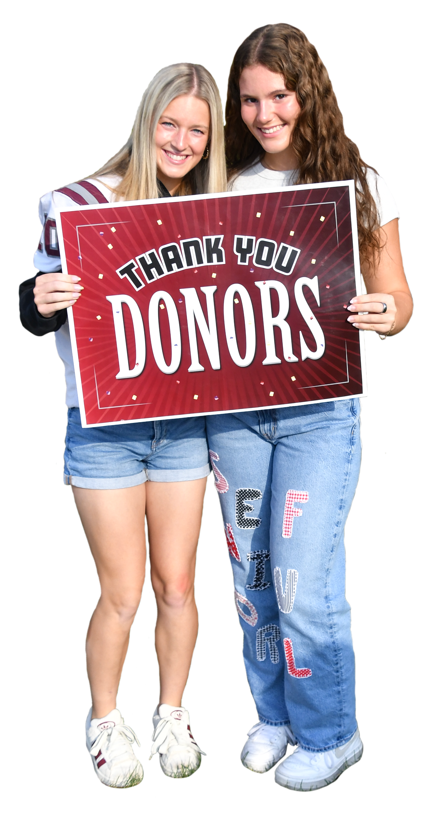 Two happy FVL girls holding a sign that says 