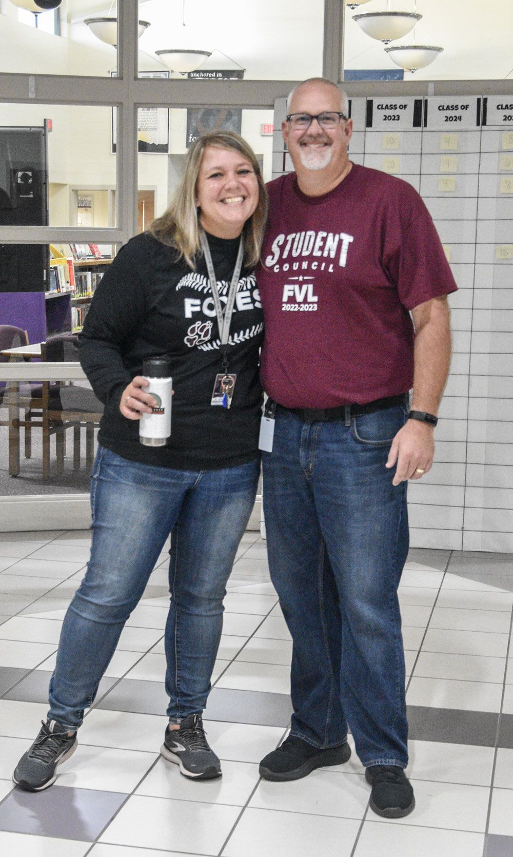 Mr. and Mrs. Uhlenbrauck in front of the Media Center windows