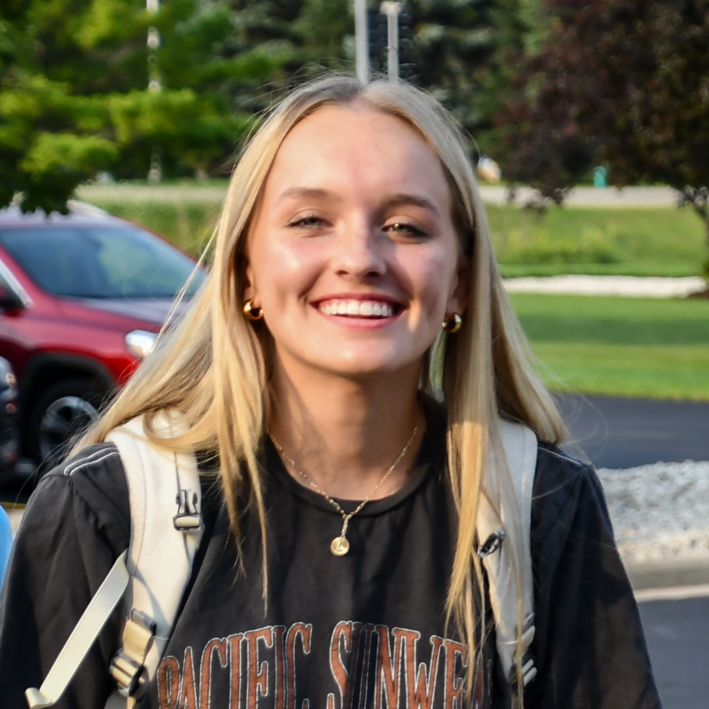 Smiling girl outside with a backpack
