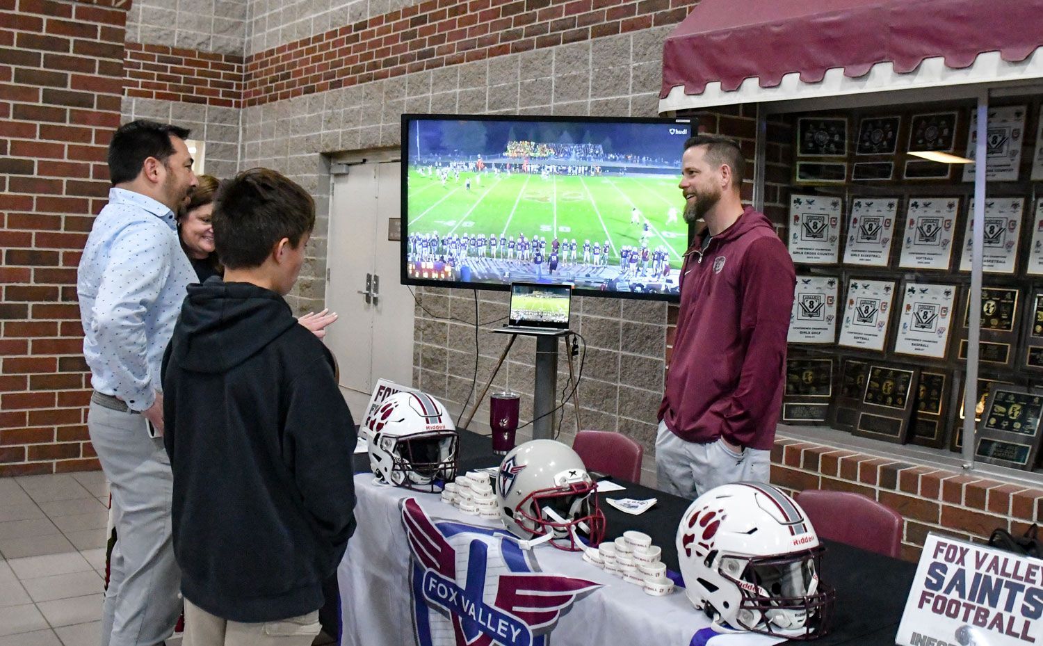 Football coach Mr. Seth Jaeger talking to some visitors