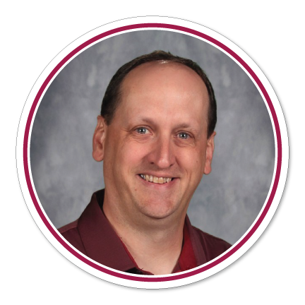 School head shot of smiling Craig Charron