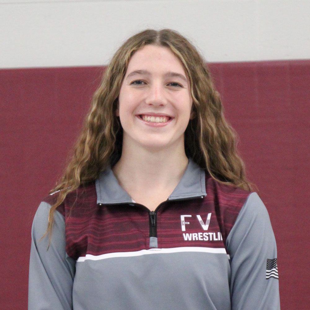 Head shot of Sophia in the gym, and in her wrestling uniform jacket