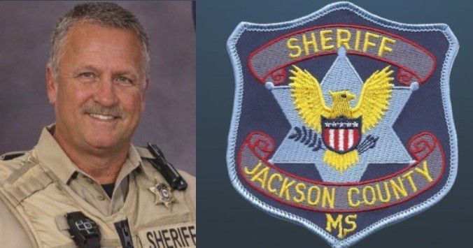 Sheriff in tan uniform beside Jackson County, MS sheriff patch