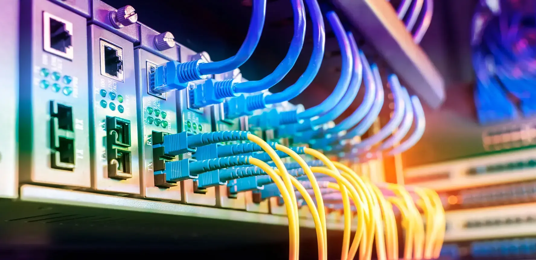 A bunch of wires are connected to a server in a data center.