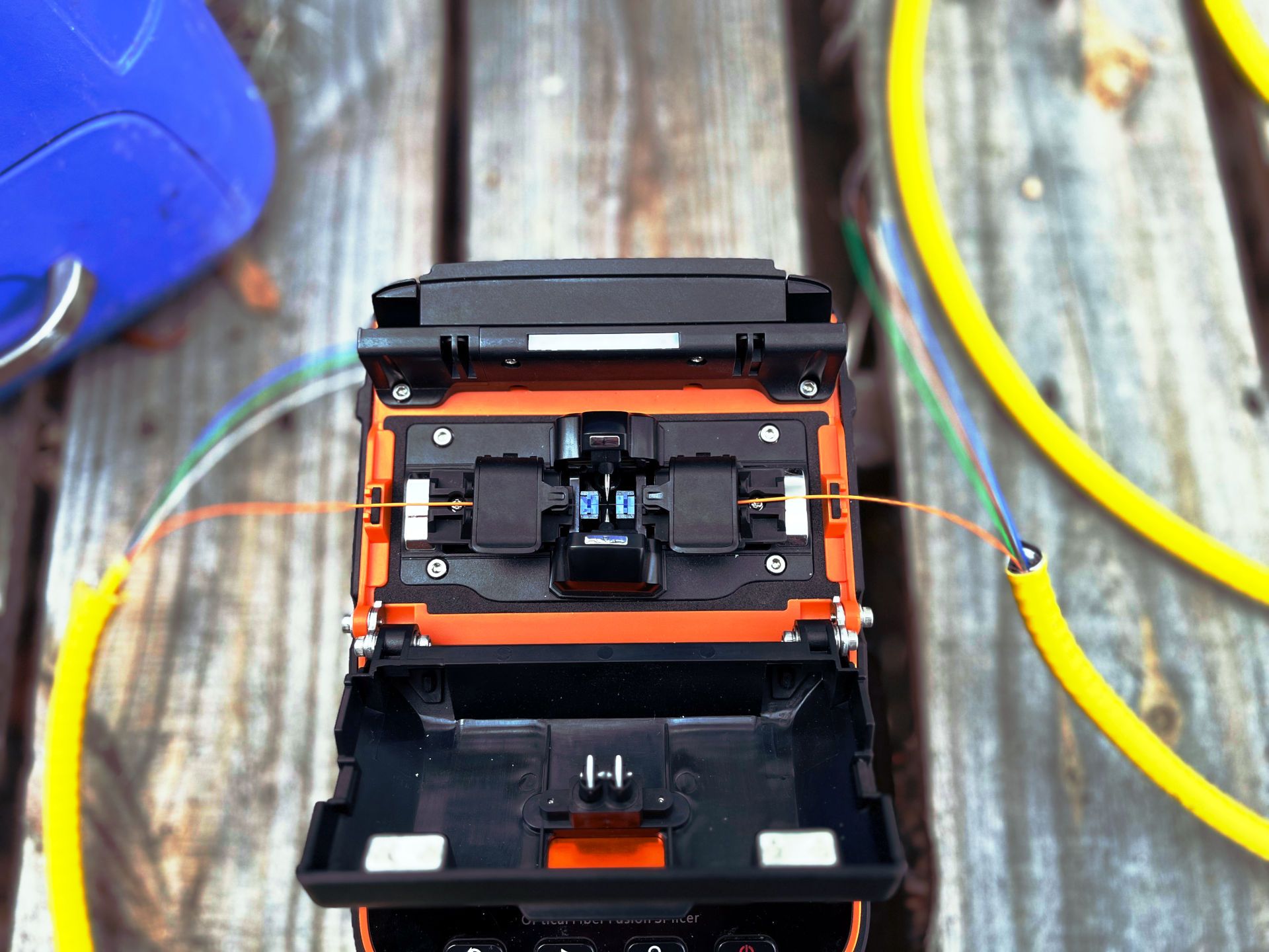 Fusion splicer with fiber strands in place Fiber fusion splicer with positioned fiber optic strands, not yet fused