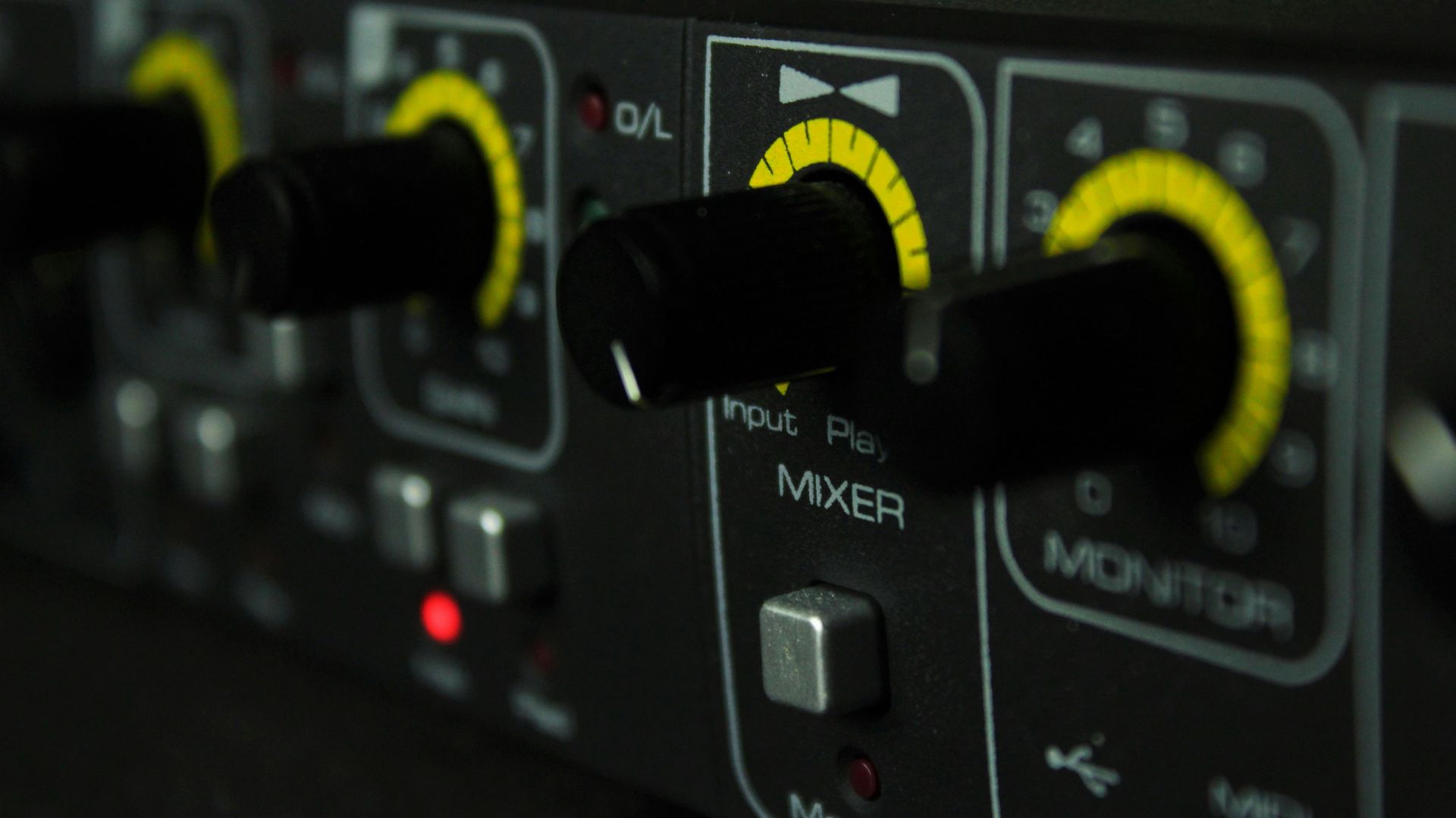 Close-up of mixer knobs, representing professional audio and visual integration solutions
