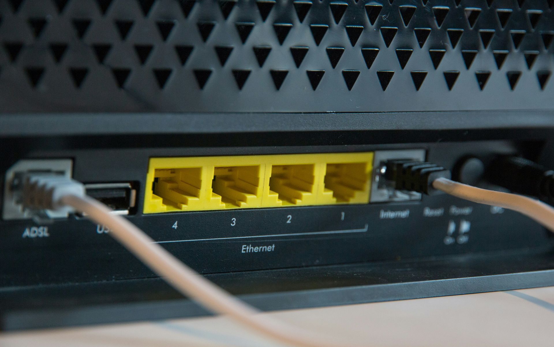 Reliable network connectivity with router Ethernet ports Rear view of a router featuring four Ethernet ports for network connectivity