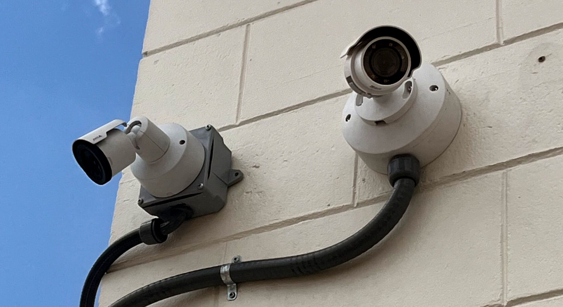 Exterior surveillance system ensuring full coverage Outdoor security cameras mounted on a building for perimeter monitoring