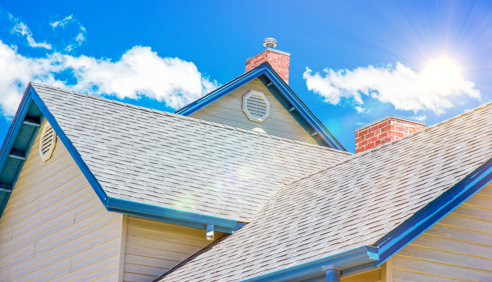 The sun is shining on the roof of a house.