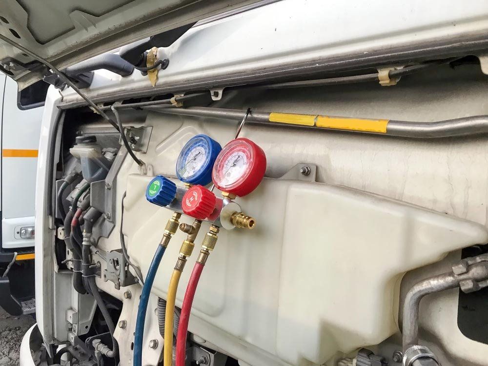 Pressure Gauge Hanging in Front of Truck — Automotive Batteries in Boonah, QLD