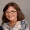 Silhouette of a person in a blazer against a light gray background